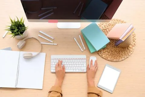 Hands of woman using computer mouse and keyboard at table in office, top view Stock Photos