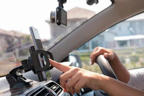 Hands of woman using mobile smart phone in the car for mobile technology appl Stock Photos