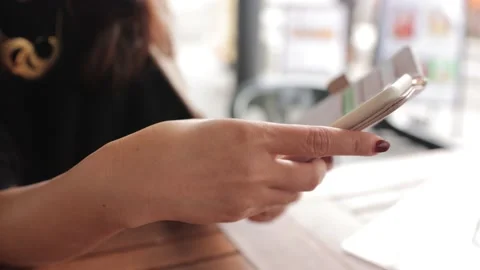 Hands of a woman using smartphone at the cafe outside. Stock Footage 224448639
