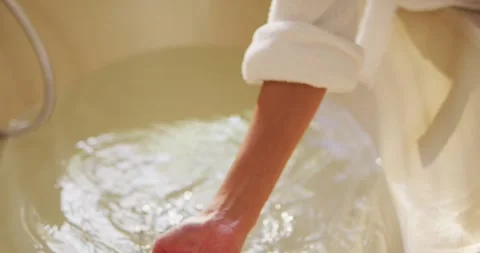 Hands of woman with vitiligo preparing bath Stock Footage 340985804