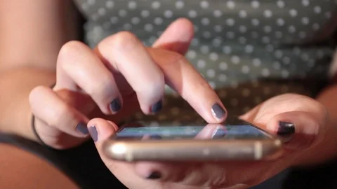 Hands of a woman while typing on smartphone Stock Footage 116337227