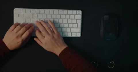 Hands Of Woman At Work Typing On Wireless Computer Keyboard. overhead shot Stock Footage 306592584