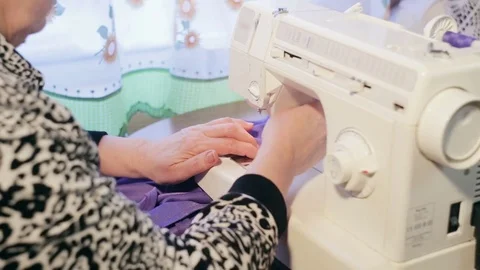 Hands of a woman working with a sewing machine. Video stock 73045188
