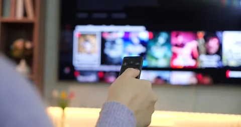 Hands women using remote control select movie streaming platform from television Stock Footage 251017580
