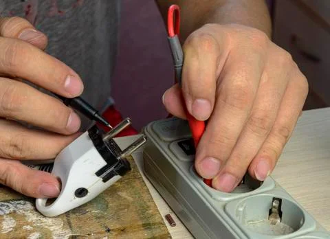 Hands at work with electrical appliances close-up Stock Photos