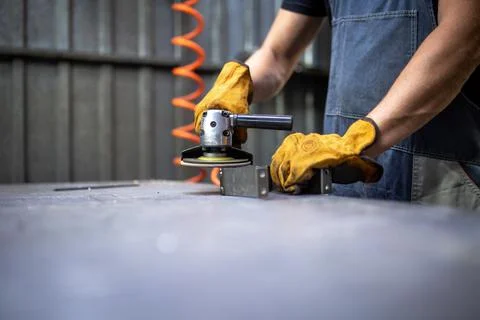 Hands work grinder tool on a metal surface Foto stock