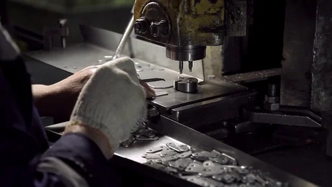 Hands work on a machine for the manufacture small metal fasteners Video stock 72681410