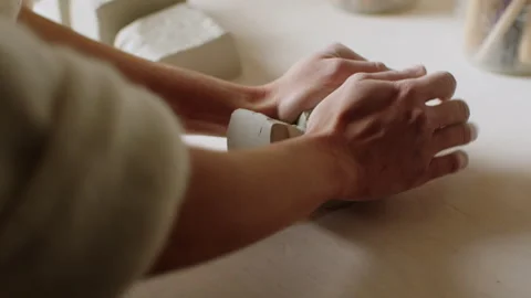 Hands at work shape ceramic creation in pottery studio Stock Footage 321539796