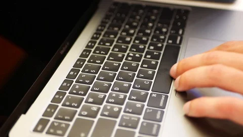 Hands work on the touchpad. close-up. Side view. Hacker. Mans hands typing on a  Stock Footage 127749855