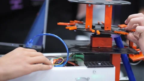 Hands work with wires near 3D printer Видео 344979454