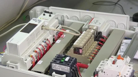 Hands of worker check contacts voltage indicator in electronics in factory. Stock Footage 79772566
