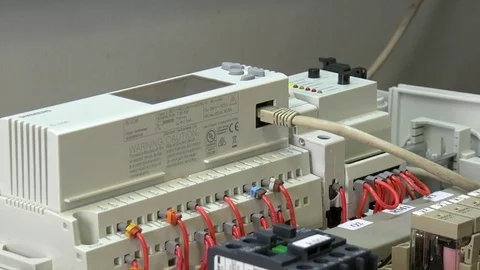 Hands of worker check contacts voltage indicator in electronics in factory. Stock Footage 82669922