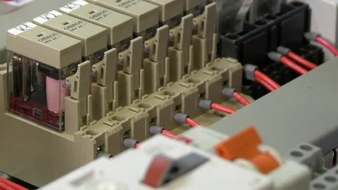 Hands of worker check contacts voltage indicator in electronics in factory. Stock Footage 82669926