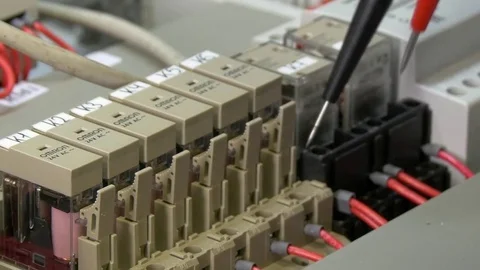 Hands of worker check contacts voltage indicator in electronics in factory. Stock Footage 82669931