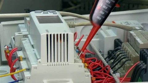 Hands of worker check contacts voltage indicator in electronics in factory. Stock Footage 82670689