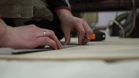 Hands of the Worker Draw The Size On a Board Stock Footage 73016439