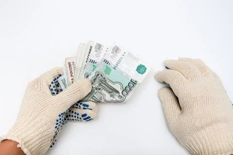 Hands of a worker, handyman, builder in protective gloves holding money, sala Stock Photos
