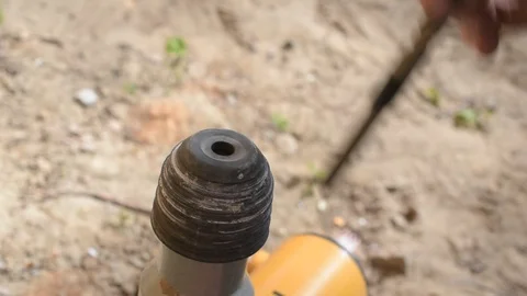 Hands of a worker inserting a drill bit into perforator outdoors Video stock 87795015