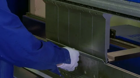 Hands of worker make figured metal corners by dint of press forms mold. Stock Footage