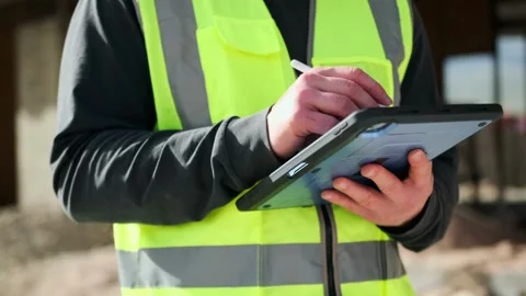 Hands of worker male engineer with tablet and stylus checking blueprints Stock Footage 275074101