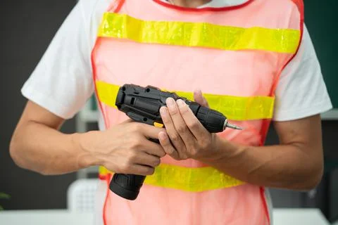 Hands of a worker with a screwdriver Stock Photos