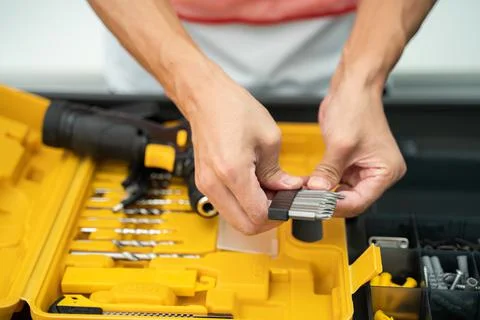Hands of a worker with a screwdriver Stock Photos