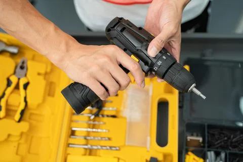 Hands of a worker with a screwdriver Stock Photos