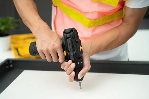 Hands of a worker with a screwdriver Foto stock