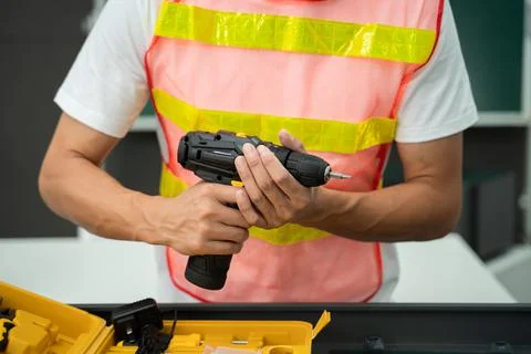 Hands of a worker with a screwdriver Stock Photos