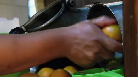 Hands of Worker Squeezing Oranges in an Argentine Restaurant - Close Up - 4K Stock Footage 293331773
