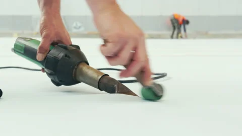 Hands of worker using roller and tool for white coating Stock Footage 230036320