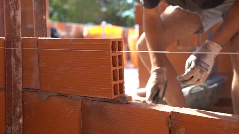 Hands of a worker at work. Laying cement and brick on brick to assemble a w.. Stock Footage 242035902