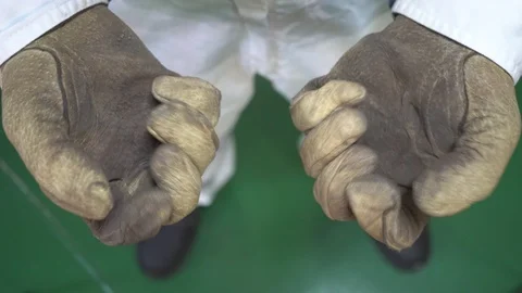 Hands of worker in yellow leather protection gloves Stock Footage 116676880