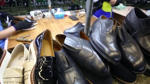 Hands of workers and new shoes in workshop of factory Stock Footage 80531259