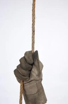 Hands of workers hanging from a rope Stock Photos
