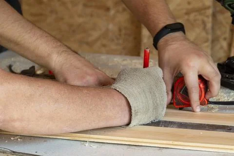 Hands of workers mark materials with a pencil, close-up. People at work Stock Photos