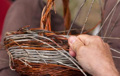 Hands working in a basket costruction Stock Photos