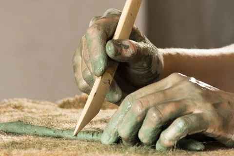 Hands working with blue clay Stock Photos