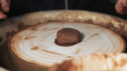 Hands working clay on potter's wheel. Potter shapes the clay product with potter Video stock 144063324