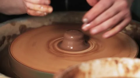 Hands working clay on potter's wheel. Potter shapes the clay product with potter Video stock 144063606