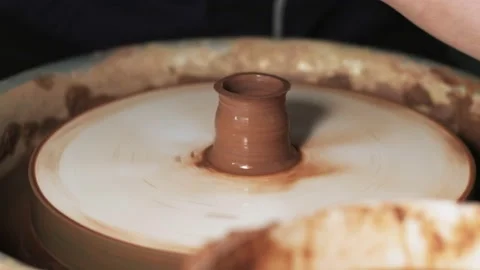 Hands working clay on potter's wheel. Potter shapes the clay product with potter Video stock 144064119