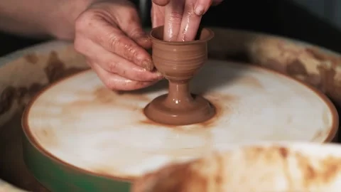 Hands working clay on potter's wheel. Potter shapes the clay product with potter Video stock 144064620