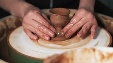 Hands working clay on potter's wheel. Potter shapes the clay product with potter Video stock 144065113
