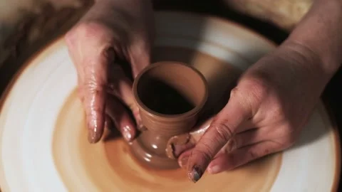 Hands working clay on potter's wheel. Potter shapes the clay product with potter Video stock 144065885