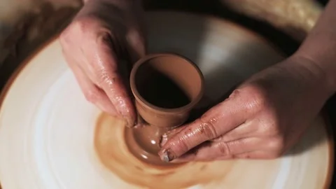 Hands working clay on potter's wheel. Potter shapes the clay product with potter Video stock 144066117