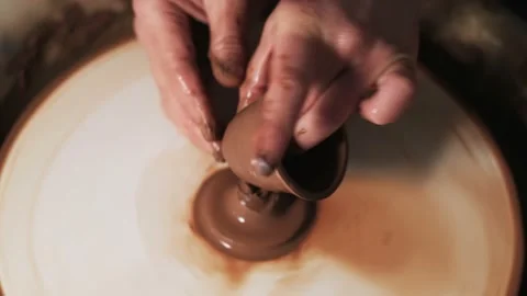 Hands working clay on potter's wheel. Potter shapes the clay product with potter Video stock 144066232