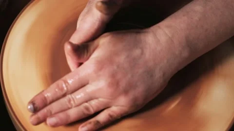 Hands working clay on potter's wheel. Potter shapes the clay product with potter Video stock 144067564