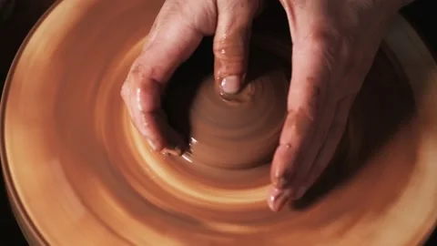 Hands working clay on potter's wheel. Potter shapes the clay product with potter Video stock 144067786