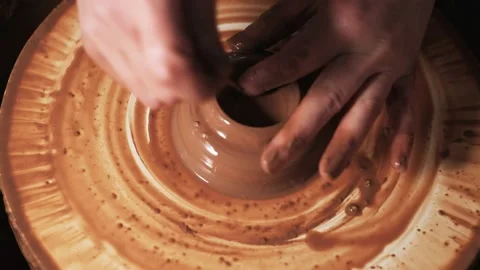 Hands working clay on potter's wheel. Potter shapes the clay product with potter Video stock 144067991