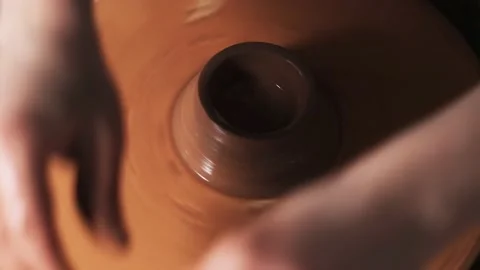 Hands working clay on potter's wheel. Potter shapes the clay product with potter Video stock 144068162